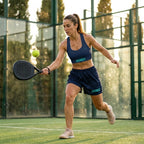 Model wearing the navy blue VAMOS Longline Sports Bra during a padel session for maximum support. lobstory.eu lobstory