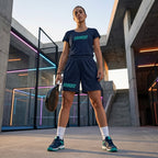 Female player on court wearing the navy blue ¡VAMOS! Performance Mesh Tee.