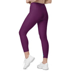 Side view mockup of burgundy ¡VAMOS! Pocket Leggings with teal vertical graphic on the leg. LOBSTORY